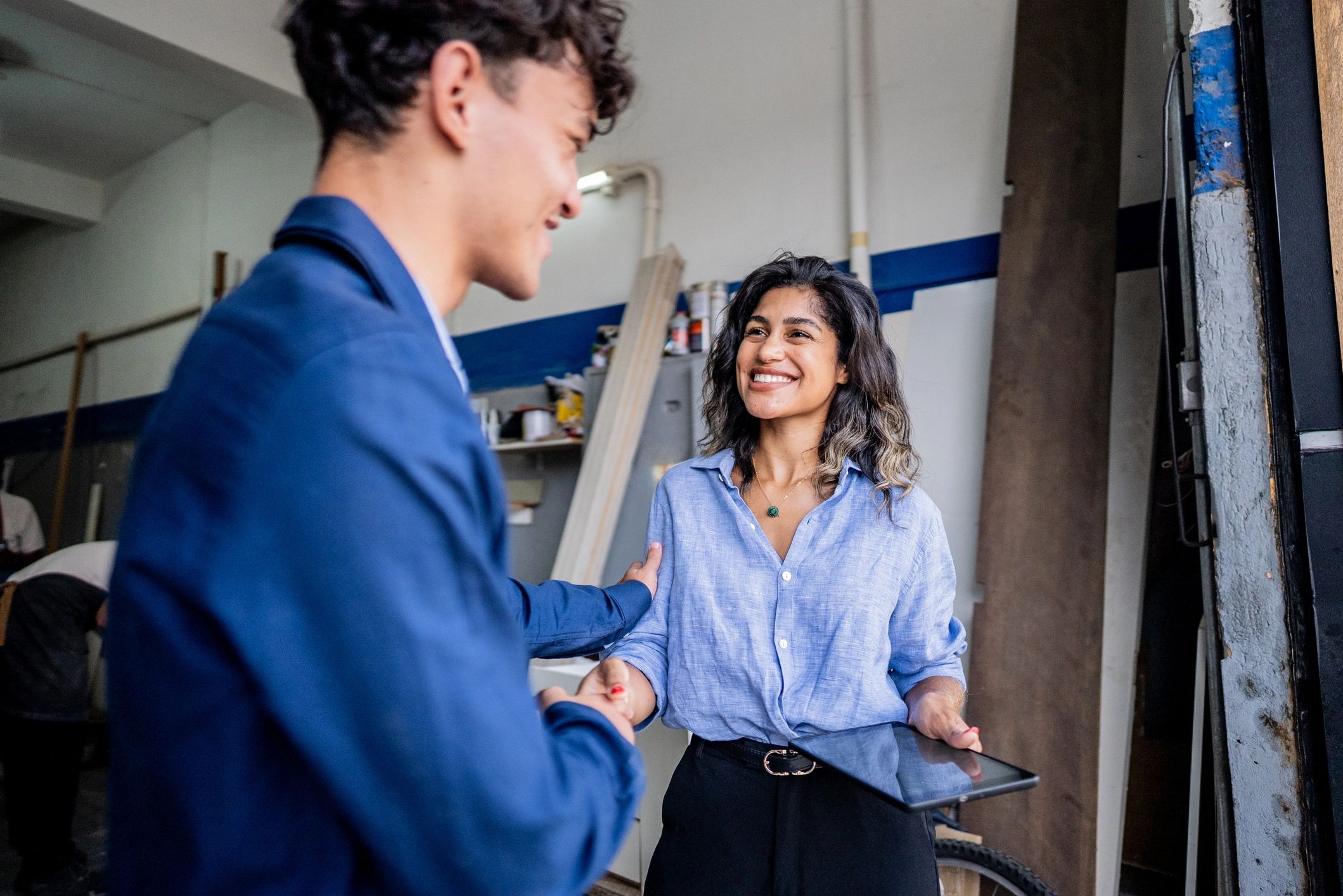 Manager greeting an employee at a workplace