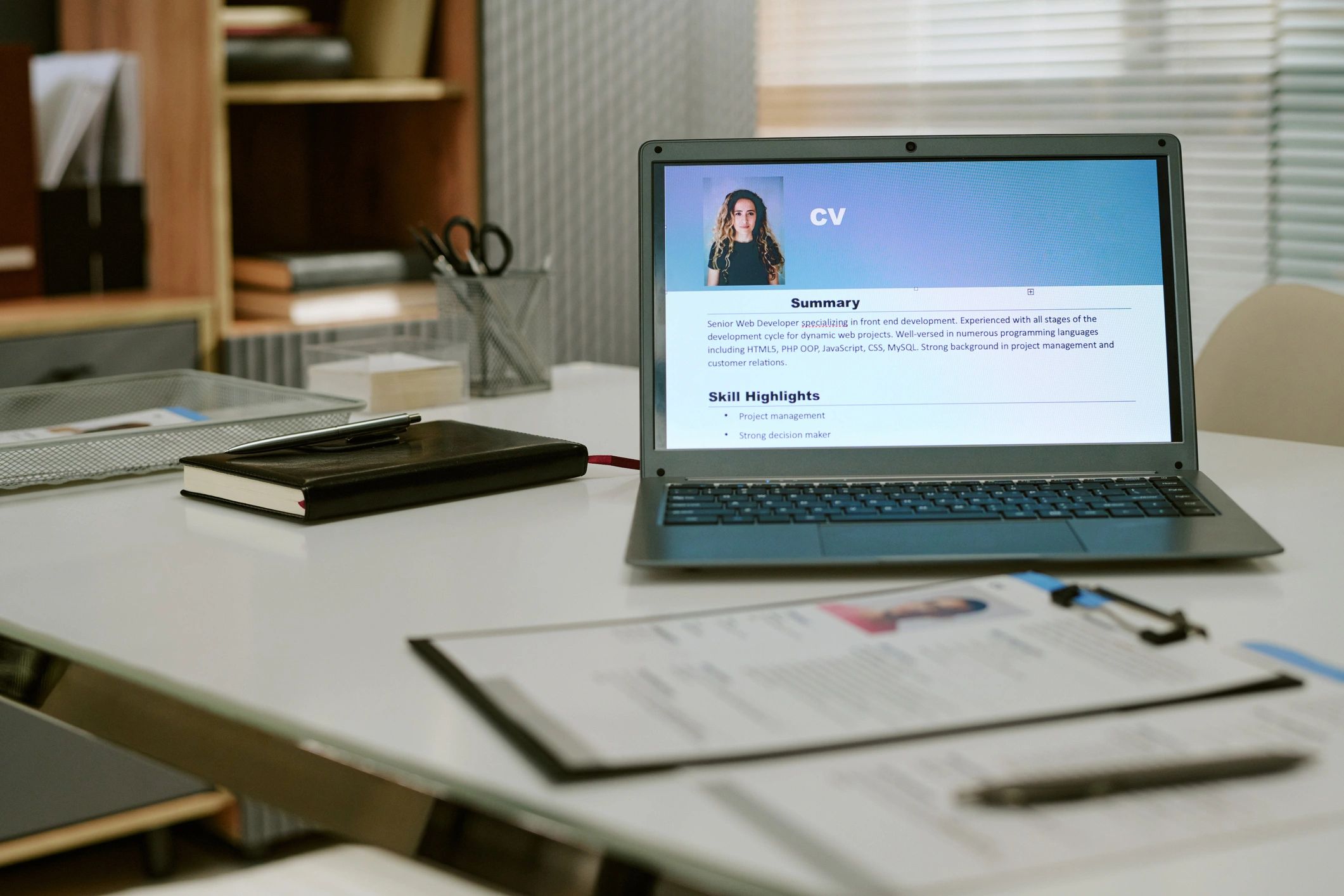 Resume review on a laptop during recruitment